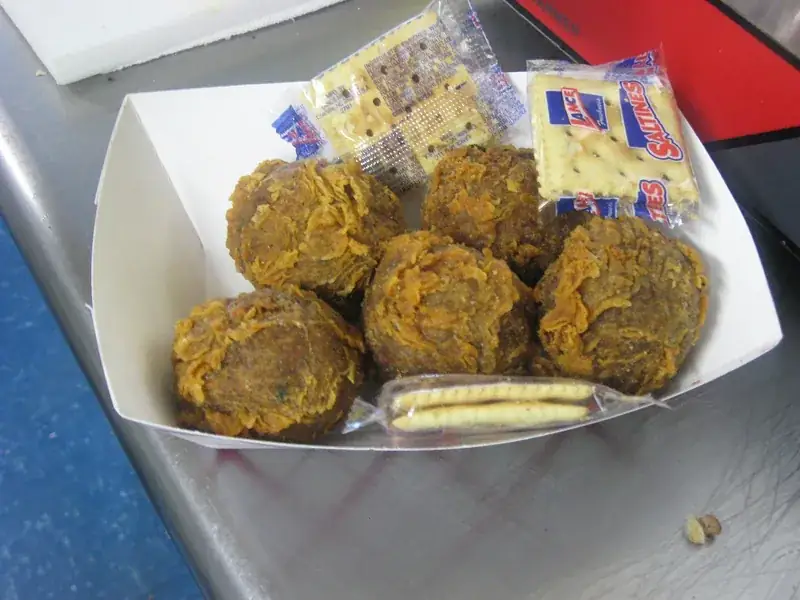Fried boudin balls with crackers in a paper boat in Cajun Country, Louisiana