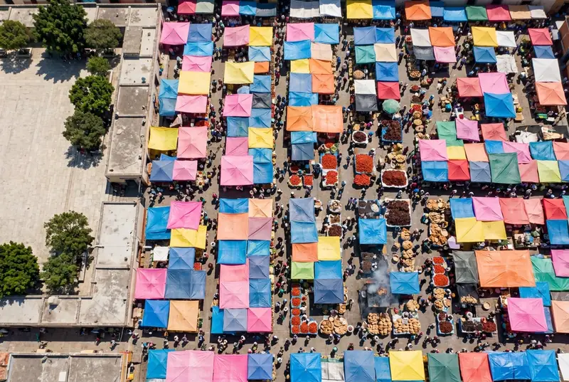 Colorful market stalls with chiles and grills seen from above at the Sunday market in Tlacolula
